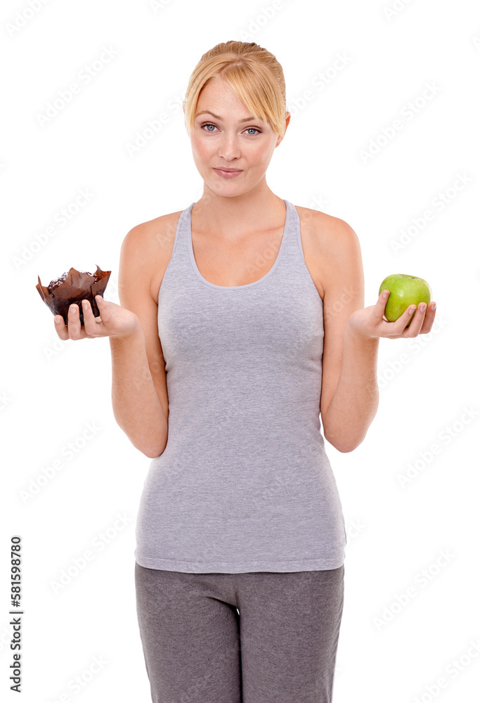 Tempted during her diet. Portrait of a young woman holding an apple and a muffin. Tempted during her diet. Portrait of a young woman holding an apple and a muffin.