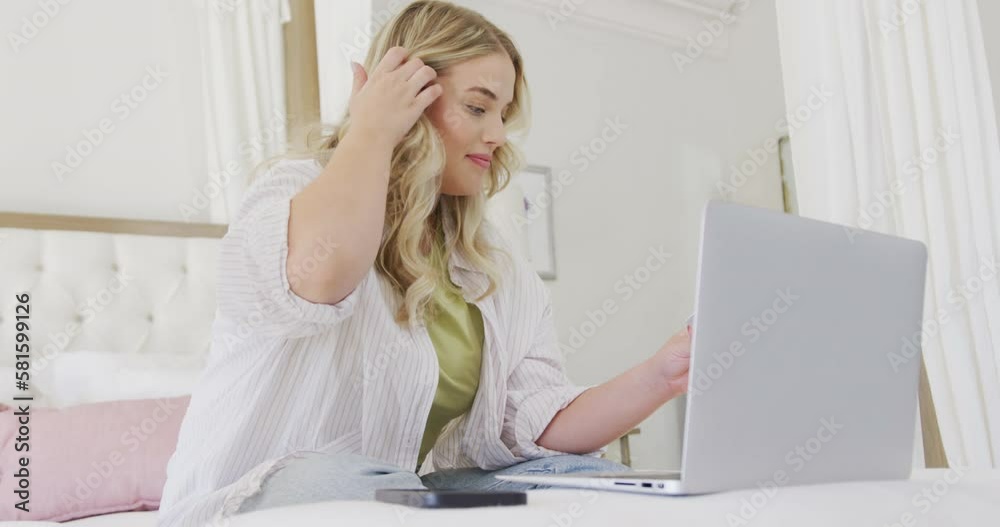 Happy caucasian plus size woman using laptop and holding credit card in slow motion Happy caucasian plus size woman using laptop and holding credit card in slow motion