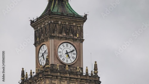 Time lapse of close-up on working city clock on Palace of Culture and Science in Warsaw in cloudy and rainy day