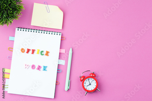 Notepad with wooden words on pink background