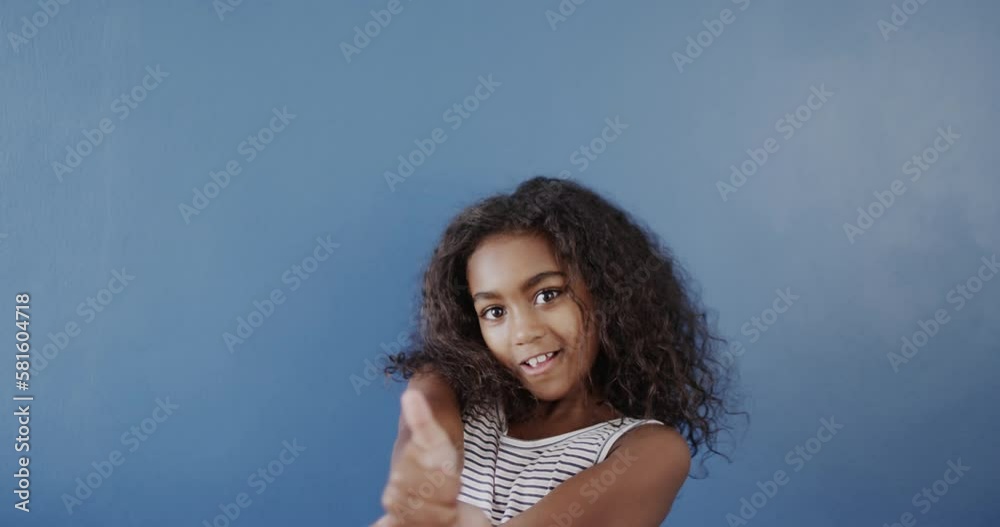 Happy african american girl using sign language on blue background, slow motion Happy african american girl using sign language on blue background, slow motion