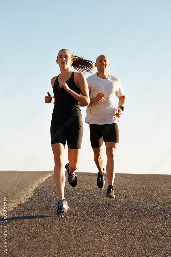 Going the distance together. a young couple exercising outdoors. Going the distance together. a young couple exercising outdoors.