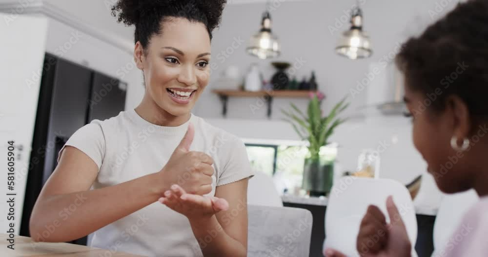 Happy african american mother and daughter using sign language, slow motion