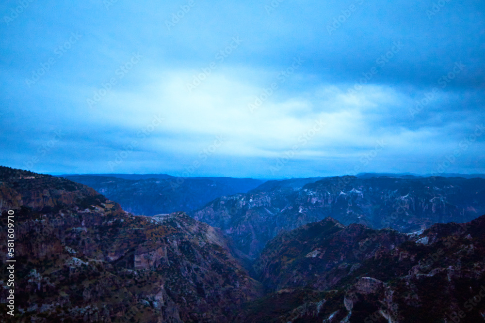blue hour in canyon with cloudy sky, blue mountains, copper canyon in sierra tarahumara, chihuahua