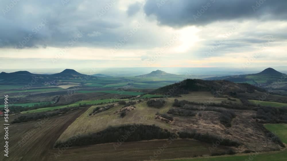 Moody aerial shot of Czech highlands, volcanic hills in Central Bohemia in early spring Moody aerial shot of Czech highlands, volcanic hills in Central Bohemia in early spring