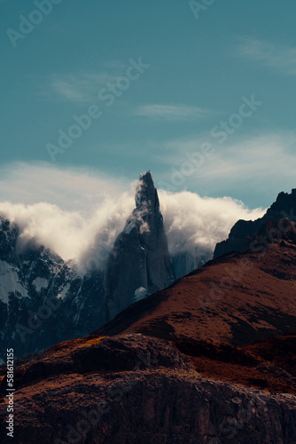 Cloudy Mist Surround Jagged Peak of Mountain Range