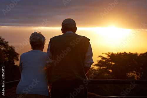 Lifetime of romance. an elderly couple looking at the view at sunset.