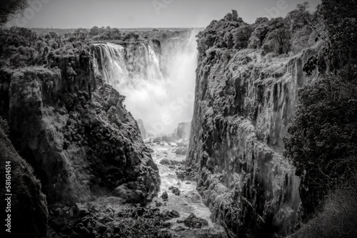 Victoria Falls, a beautiful waterfall and national landmark in Africa, is seen from the Zimbabwe side. Black and white.