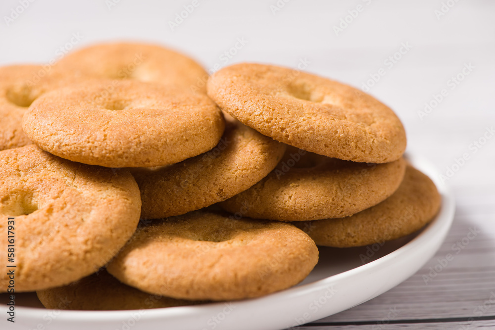closeup of crispy round biscuits. Sweet cookies on wooden table.