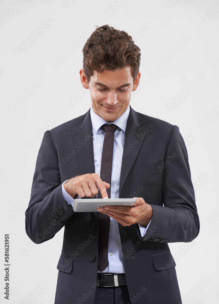 All my information is in the palm of my hands. a handsome young businessman using a digital tablet. All my information is in the palm of my hands. a handsome young businessman using a digital tablet.