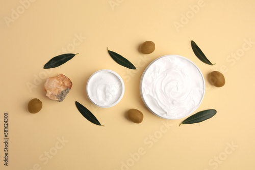 Natural cosmetic. Different olive creams, mineral and ingredient on beige background, flat lay