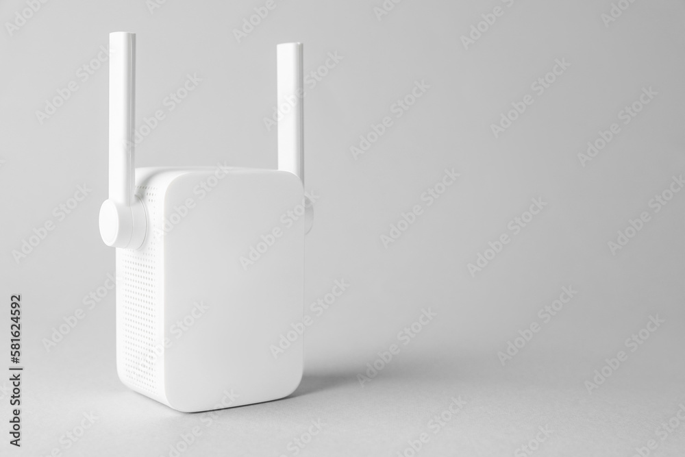 New modern Wi-Fi repeater on light gray background, space for text New modern Wi-Fi repeater on light gray background, space for text