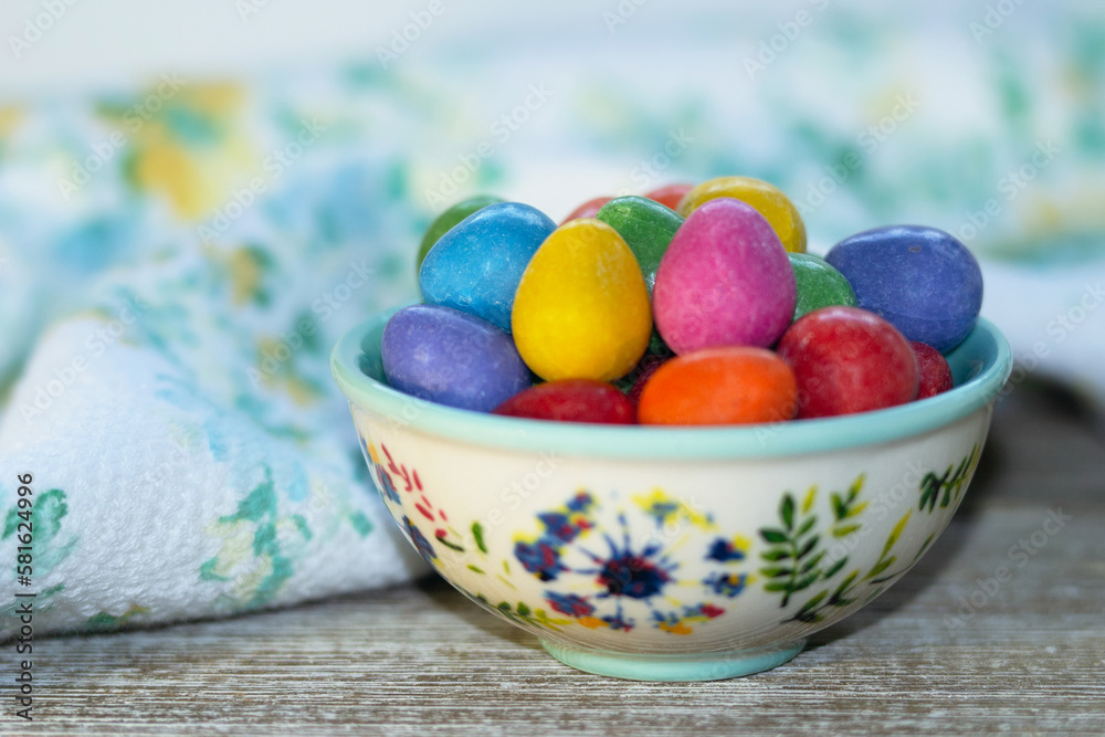 Multicolored chocolate Easter eggs in a ceramic bowl on the table. Multicolored chocolate Easter eggs in a ceramic bowl on the table.