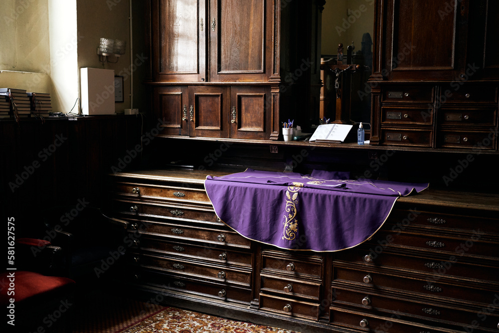 Sacristy inside the catholic church, priest chasuble, lent, purple liturgical vestments