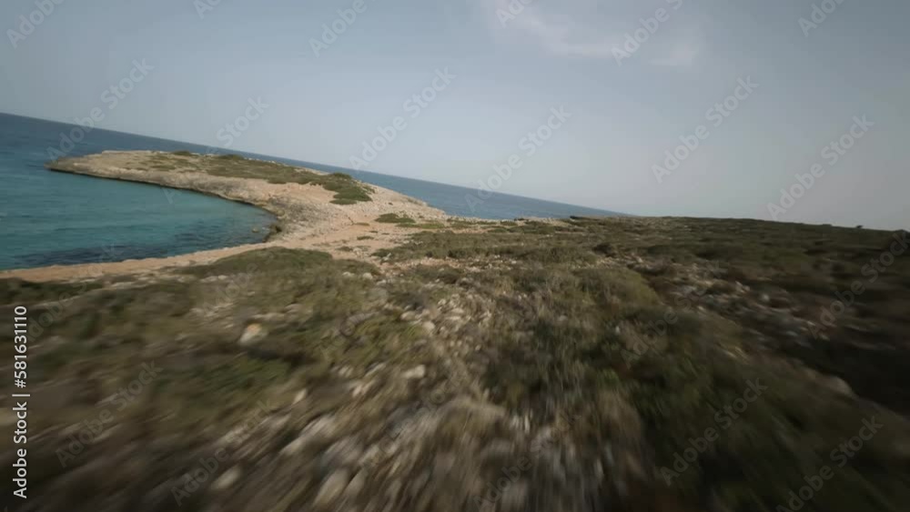 FPV drone timelapse shot of steep cliffs along the seaside with sailboats docked in Cala Varques, Mallorca, Spain during evening time. FPV drone timelapse shot of steep cliffs along the seaside with sailboats docked in Cala Varques, Mallorca, Spain during evening time.