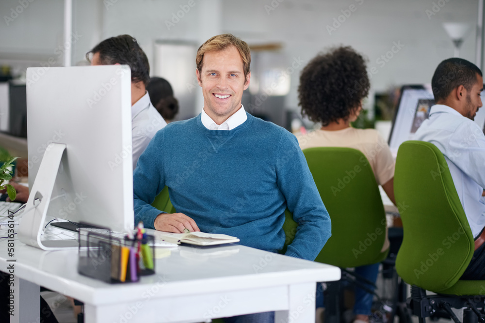 Im crushing this deadline. Portrait of a creative businessman sitting behind of his computer in the office. Im crushing this deadline. Portrait of a creative businessman sitting behind of his computer in the office.