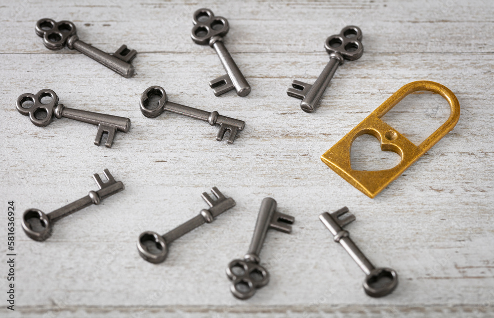 Looking for love, open for love, multiple options concept. Padlock with heart simulate looking for romance and many keys on white wood surface. Looking for love, open for love, multiple options concept. Padlock with heart simulate looking for romance and many keys on white wood surface.
