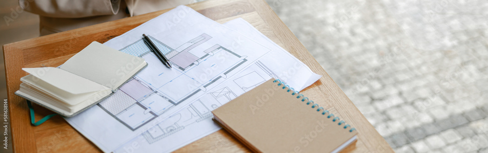 Close up of businesswoman architect drinking coffee while working on project while sitting in cafe Close up of businesswoman architect drinking coffee while working on project while sitting in cafe