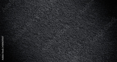 Black concrete textured empty wall background wide format.