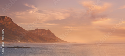 Sunset over the Cape coast. Lions Head seen from across the ocean at sunset.