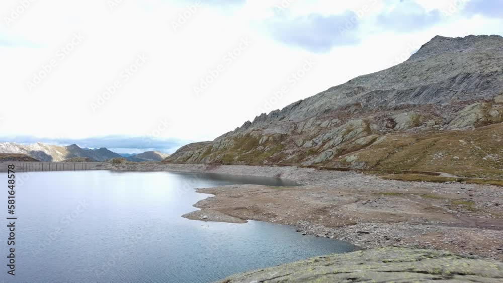 Lake surrounded by hills and rocky areas in Switzerland, Lake Naret. Aerial drone shot. Lake surrounded by hills and rocky areas in Switzerland, Lake Naret. Aerial drone shot.