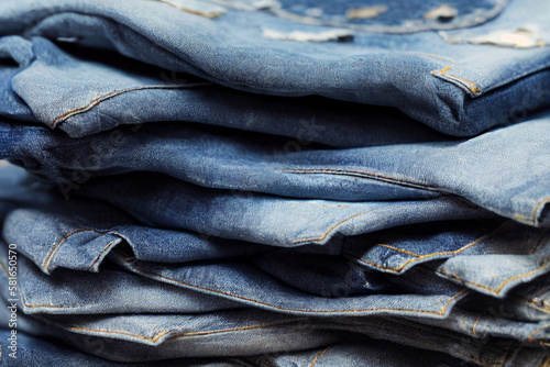 A pile of blue jeans with the word denim on it . Generative ai