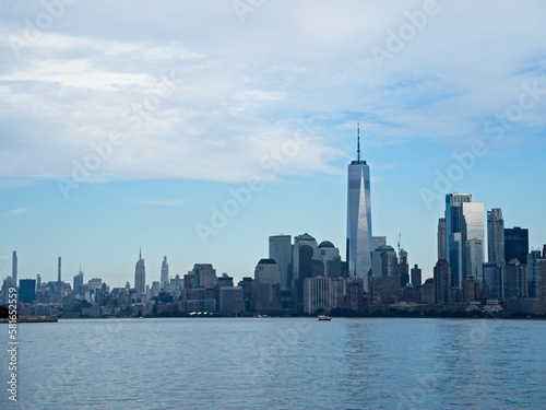 Looking back on Manhattan from the Hudson River and Liberty Island  as the towering high rises of Lower Manhattan loom above the river