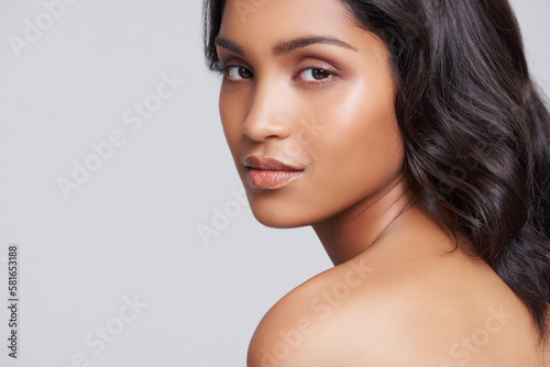 Serene beauty. a beautiful young posing over a gray background.