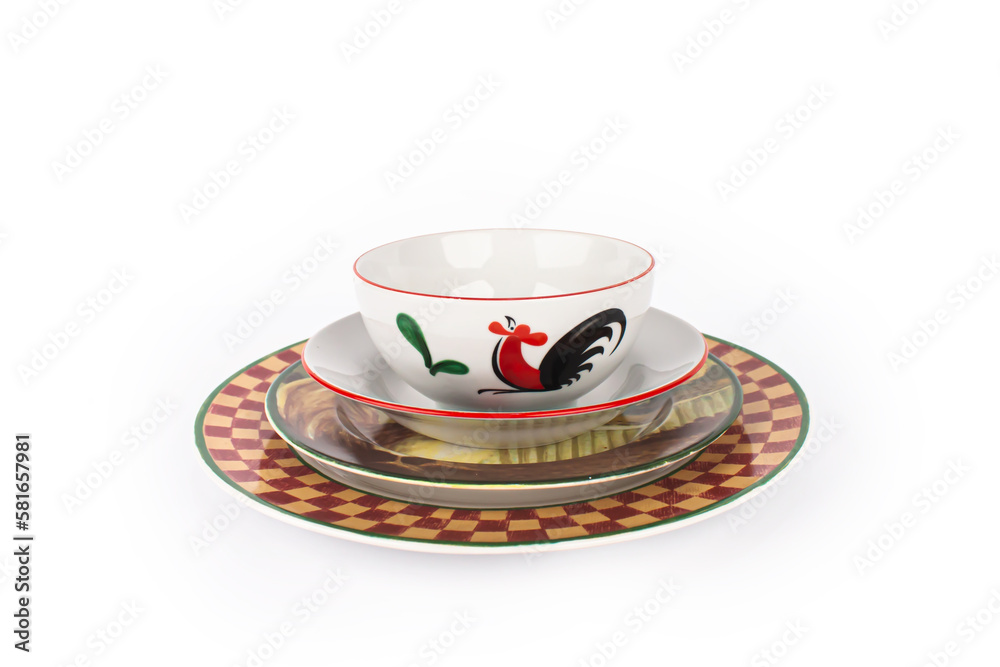 Red and yellow ceramic plate and white chicken bowl on top Isolated on white background Red and yellow ceramic plate and white chicken bowl on top Isolated on white background