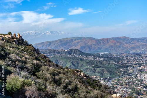 Breathtaking view from Lookout Roadhouse restaurant overlooking North Lake Elsinore, Calif with Orange Poppy covered mountains mid-range with the snowcapped San Bernadino Mountains in the background. photo
