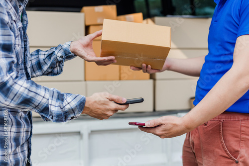 delivery concept Asian male customer receiving boxes from professional courier at home.