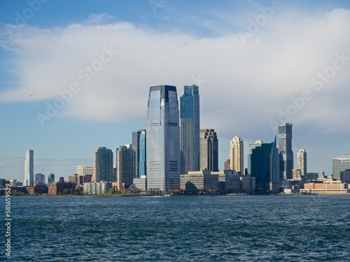Looking back on Manhattan from the Hudson River and Liberty Island  as the towering high rises of Lower Manhattan loom above the river