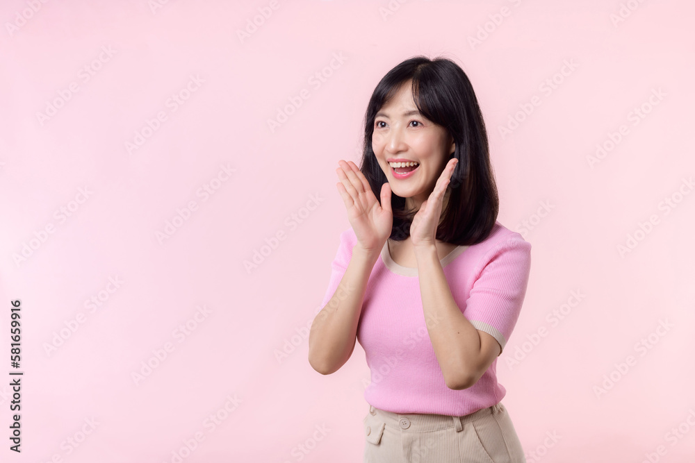Portrait beautiful young asian woman expression yel scream announce news of communication message or shout loud voice with hand beside mouth gesture isolated on pink pastel background. Portrait beautiful young asian woman expression yel scream announce news of communication message or shout loud voice with hand beside mouth gesture isolated on pink pastel background.