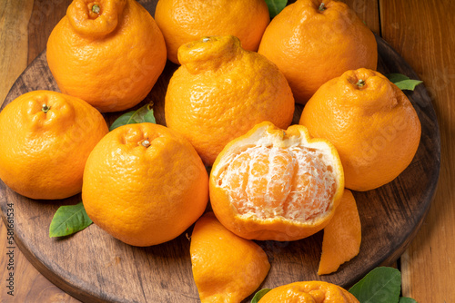 Fresh Orange fruit on Wooden table, Dekopon orange or sumo mandarin tangerine on wooden background. photo