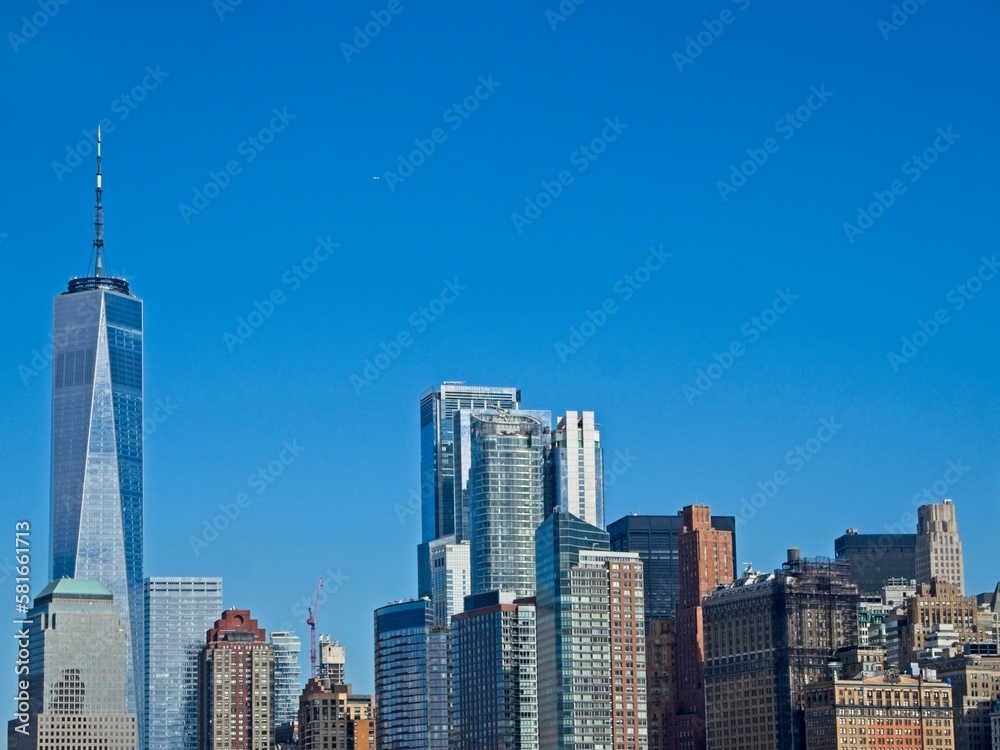 Looking back on Manhattan from the Hudson River and Liberty Island, as the towering high rises of Lower Manhattan loom above the river Looking back on Manhattan from the Hudson River and Liberty Island, as the towering high rises of Lower Manhattan loom above the river