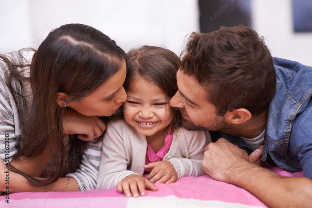 On the receiving end of a whole lot of love. an affectionate young family at home. On the receiving end of a whole lot of love. an affectionate young family at home.