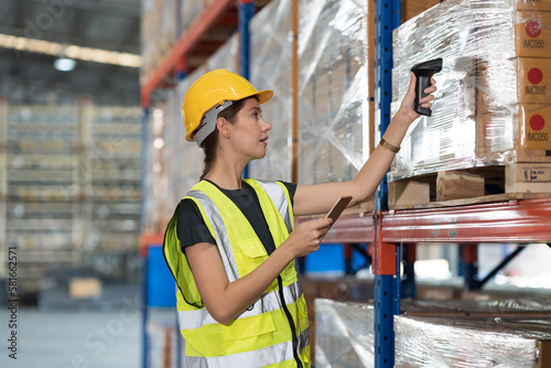 Caucasian female female warehouse worker working at work scanning barcode on products boxes for checks stock, inventory with tablet on shelf pallet in the storage warehouse