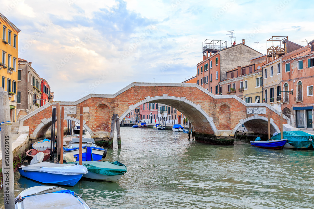 Venice, Italy - July 17, 2019: Residential Venice in the morning. Canale di Cannaregio (Rio di Cannaregio) Tre Archi Bridge