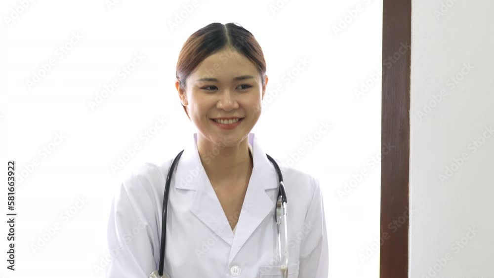 Young Asian female doctor performing dance moves and smiling expressions to relax before work. Young Asian female doctor performing dance moves and smiling expressions to relax before work.