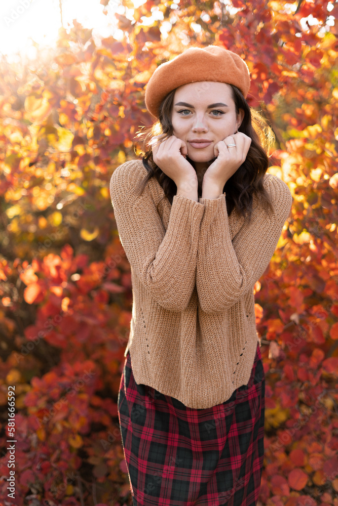 Outdoor fashion photo of young beautiful woman surrounded orange autumn leaves. Vertical view Outdoor fashion photo of young beautiful woman surrounded orange autumn leaves. Vertical view