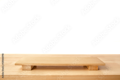 Empty sushi board on wood table with white background. Top view of plank wood for graphic stand product, interior design or montage display your product.