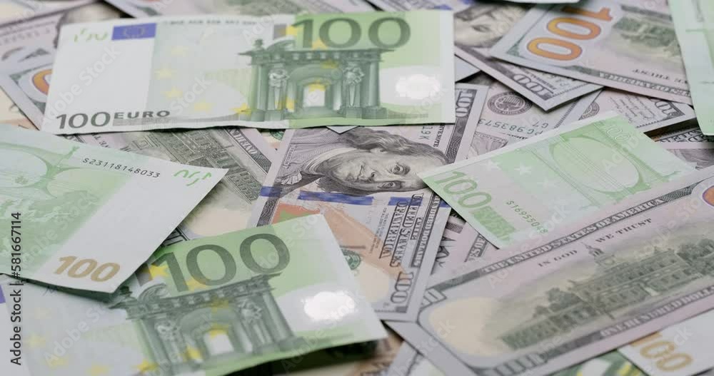 Cash USD and EURO money background - One hundred dollar and euro banknotes rotate in close up macro view Cash USD and EURO money background - One hundred dollar and euro banknotes rotate in close up macro view