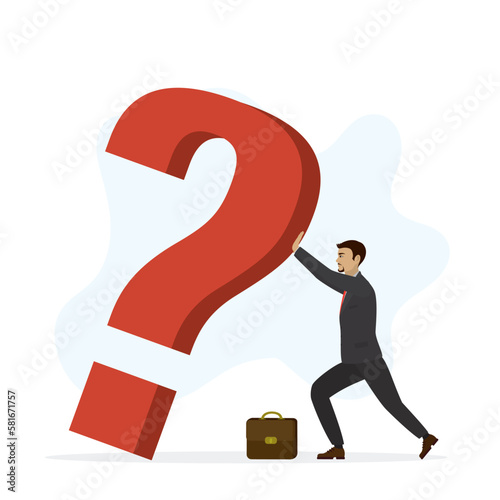 Unsure businessman trying to hold up huge question mark. The entrepreneur has many business problems and difficulties. Unresolved issues put pressure on employee.