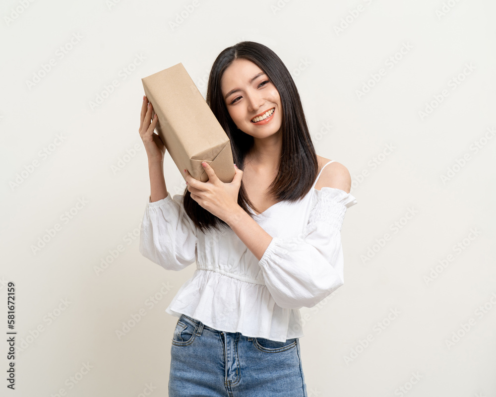 Young excited beautiful asian woman with parcel cardboard standing on isolated background. Cheerful female holding lot of parcel box receive from the delivery service shopping online application Young excited beautiful asian woman with parcel cardboard standing on isolated background. Cheerful female holding lot of parcel box receive from the delivery service shopping online application