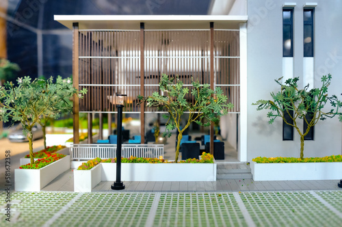 Overview of facade of modern contemporary miniature model  luxury housing. Focus on trees and plants on the exterior. Construction  home architecture  property and real estate concept