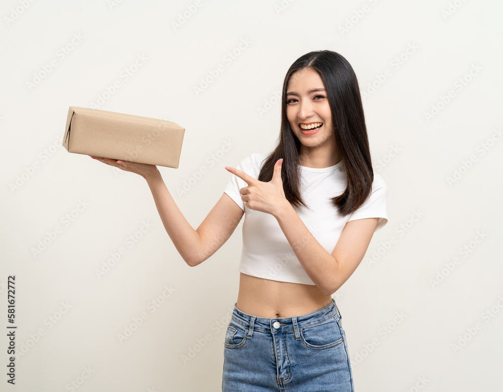 Young excited beautiful asian woman with many parcel cardboard standing on isolated white background. Cheerful female holding lot of parcel box receive from the delivery service Young excited beautiful asian woman with many parcel cardboard standing on isolated white background. Cheerful female holding lot of parcel box receive from the delivery service