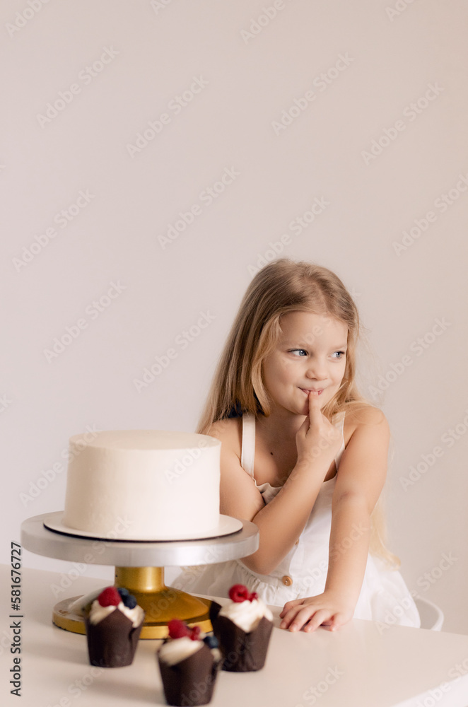 Beautiful happy little girl biting birthday cake. Festive and holiday concept. Beautiful happy little girl biting birthday cake. Festive and holiday concept.