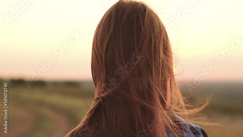 girl tousled hair wind. silhouette girl. man journey sunset. look into distance. female travel picnic. beautiful girl against backdrop heavenly sunset evening. free feeling life. woman hair wind