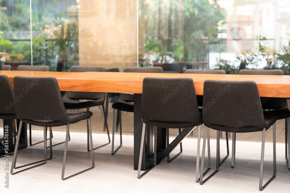 Table and chairs in meeting room. Meeting room professional board room lit by natural light chairs and table empty nobody. 