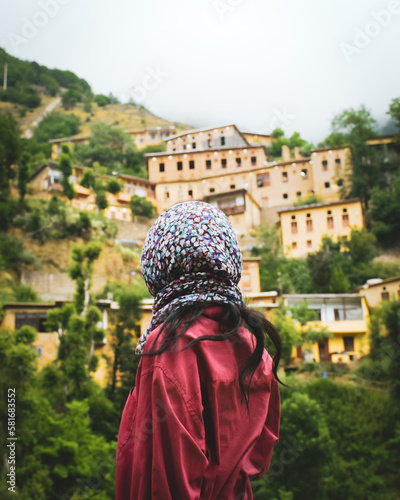 Tourist woman stand enjoy scenic Masuleh village panorama in north east Iran - popular famous tourism destination in persia photo